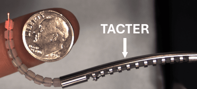 TACTER continuum robot held beside a US dime for scale